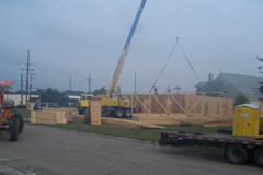 Truck crane used to set roof trusses